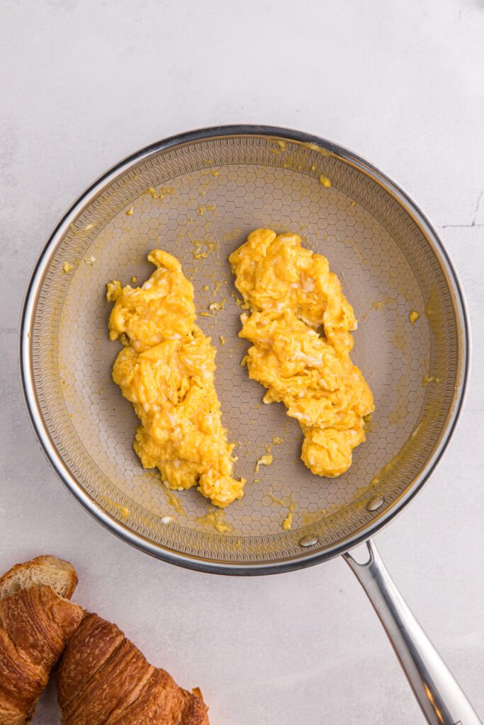 Top down image showing scrambled eggs inside a skillet