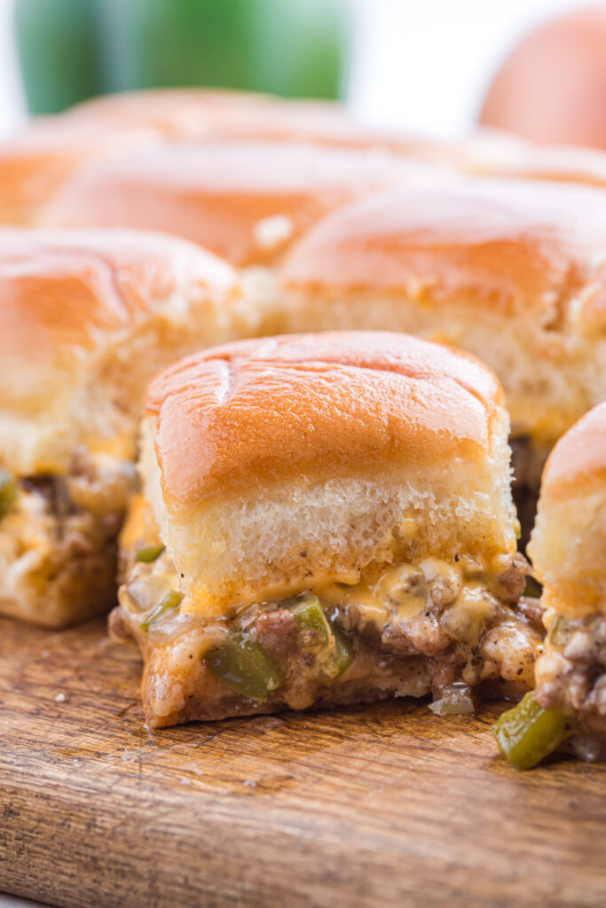 close up image showing a slider filled with ground beef and melted cheese
