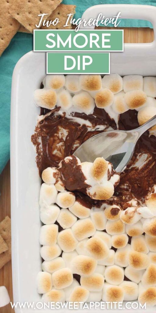 Top down image showing a rectangle baking dish filled with toasty marshmallows with melted chocolate being scooped out on a spoon. Text overlay reads "two ingredient smore dip"