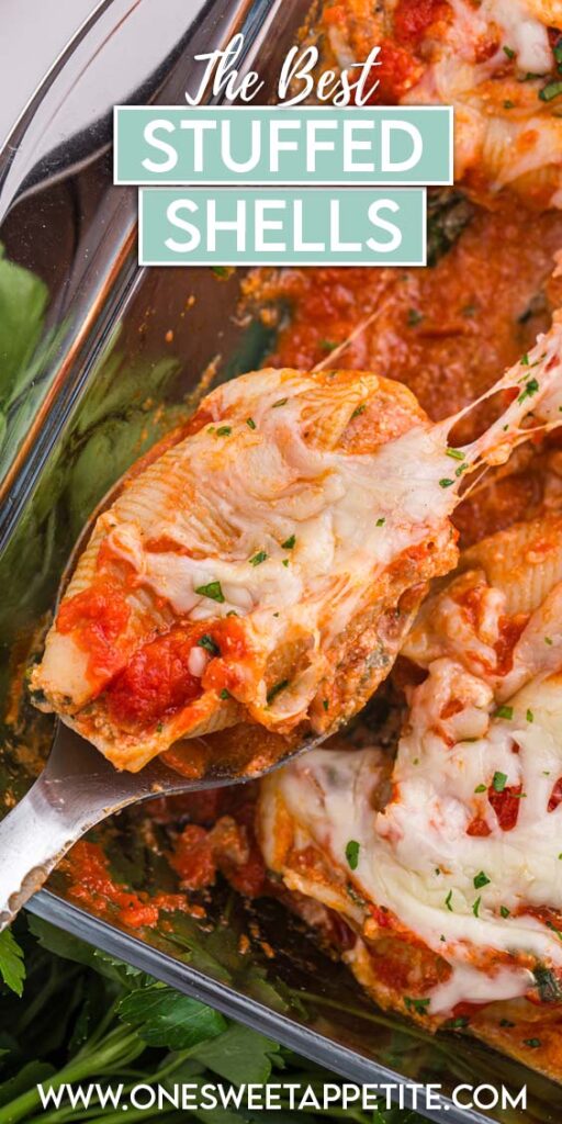 Top down image showing a glass baking dish filled with pasta shells that are topped with red sauce and cheese. One shell is being pulled out of the pan with a white serving spoon. Text overlay reads "the best stuffed shells"