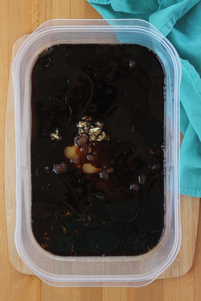 top down image showing a plastic dish filled with marinade