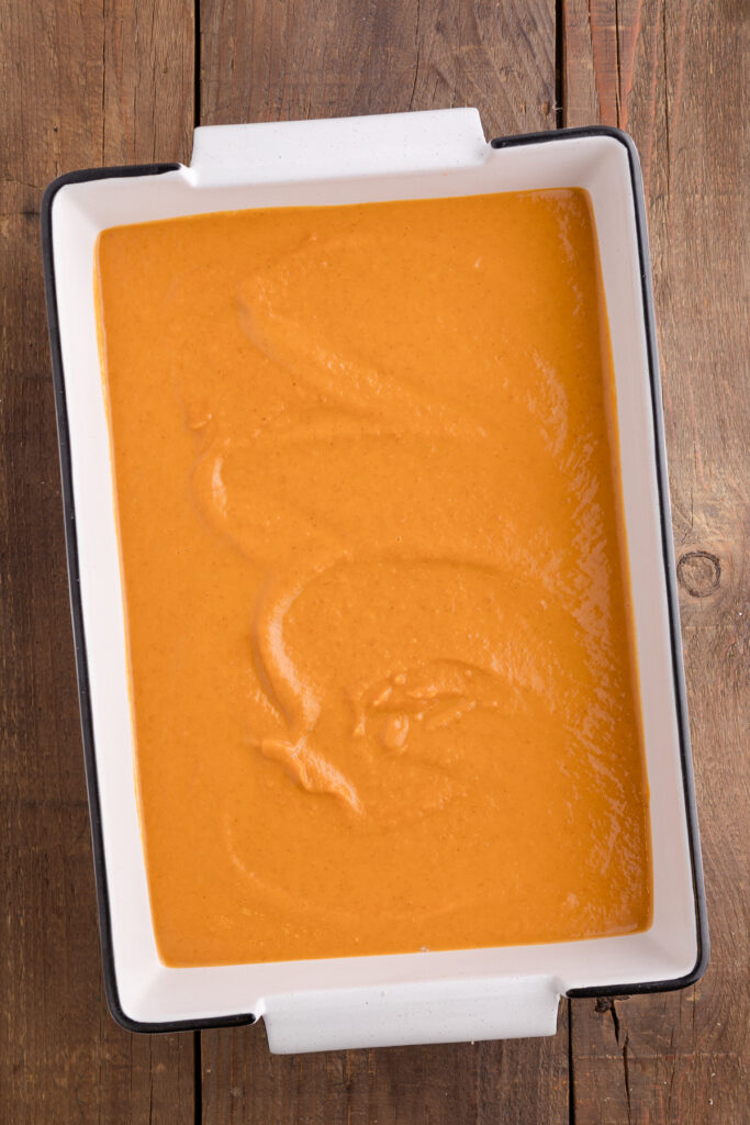 top down image showing a white baking dish with a pumpkin batter