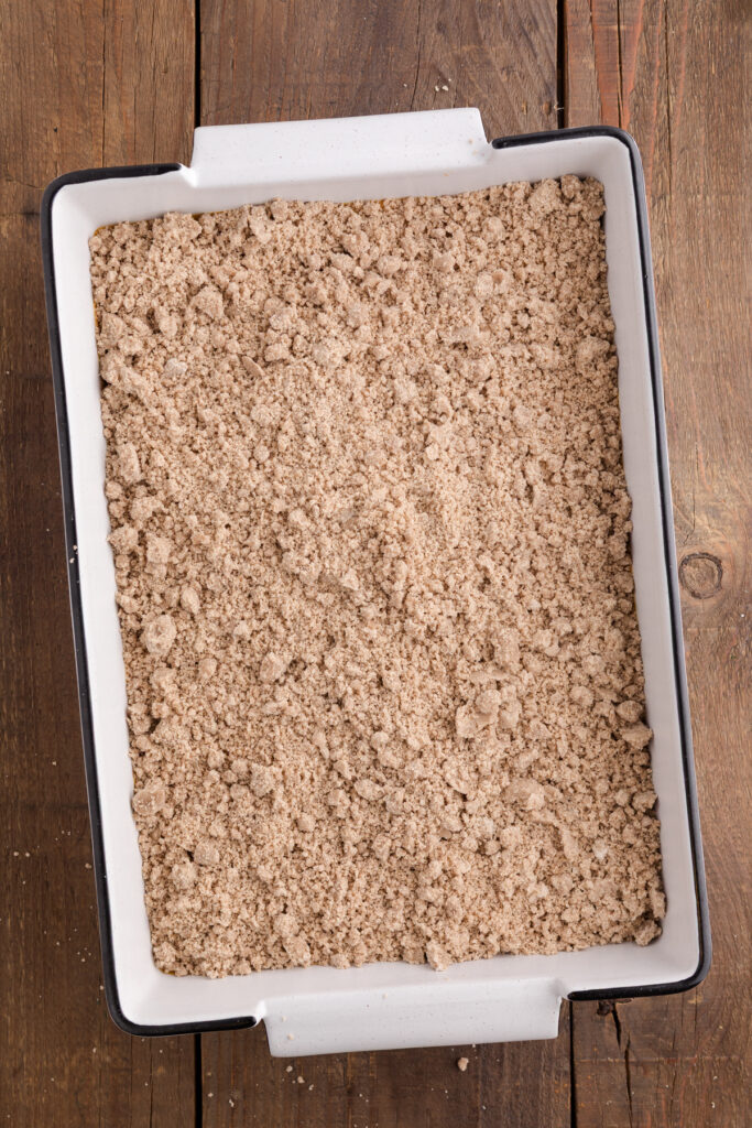 top down image showing a white baking dish with a crumb topping