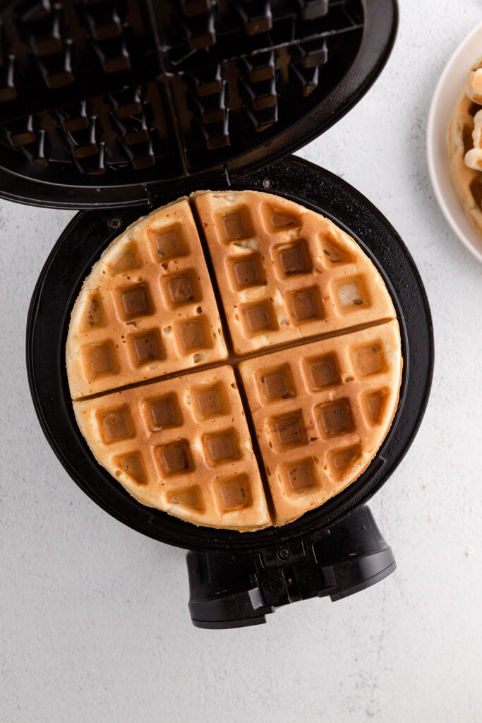 top down image showing a waffle iron with waffles inside