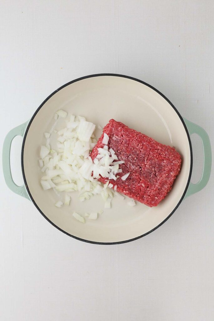 top down image showing a skillet with ground beef and chopped onion