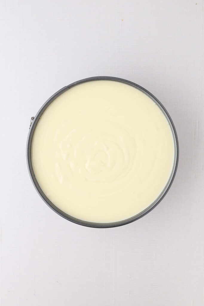 Top down image showing a springform pan filled with cheesecake batter
