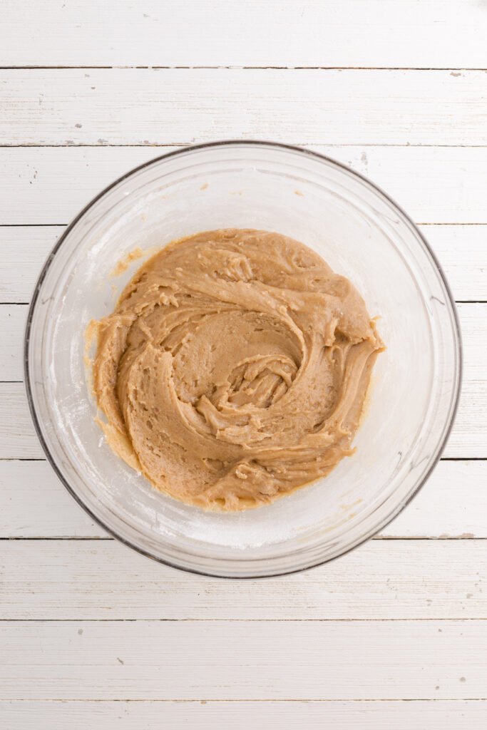 Top down image showing a glass bowl filled with a mixed batter