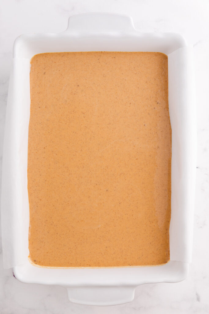 top down image showing a white baking dish filled with unbaked pie filling