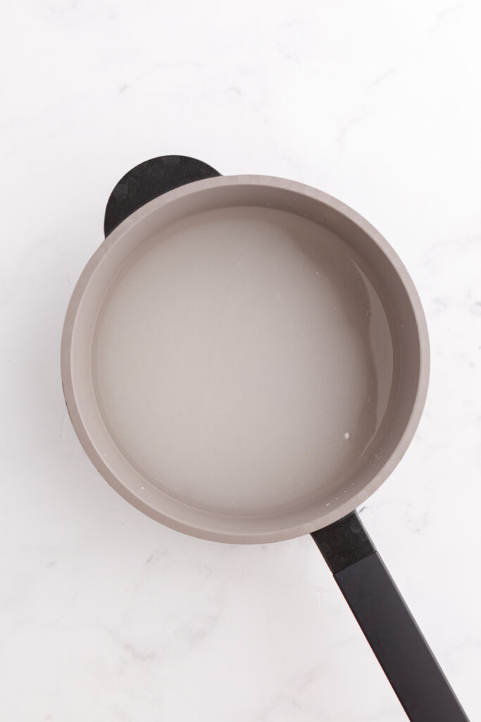 Top down image showing a pot filled with water and sugar