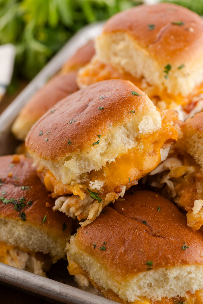 Close-up of chicken bacon ranch sliders with golden rolls and melted cheese