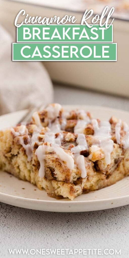 close up image showing a cut out piece of cinnamon roll bake with a glaze on top sitting on a white plate. Text overlay reads cinnamon roll breakfast casserole