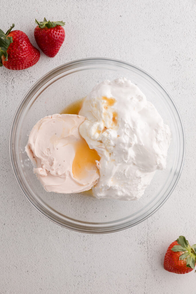 strawberry cream cheese, marshmallow creme, orange juice and vanilla in a glass mixing bowl