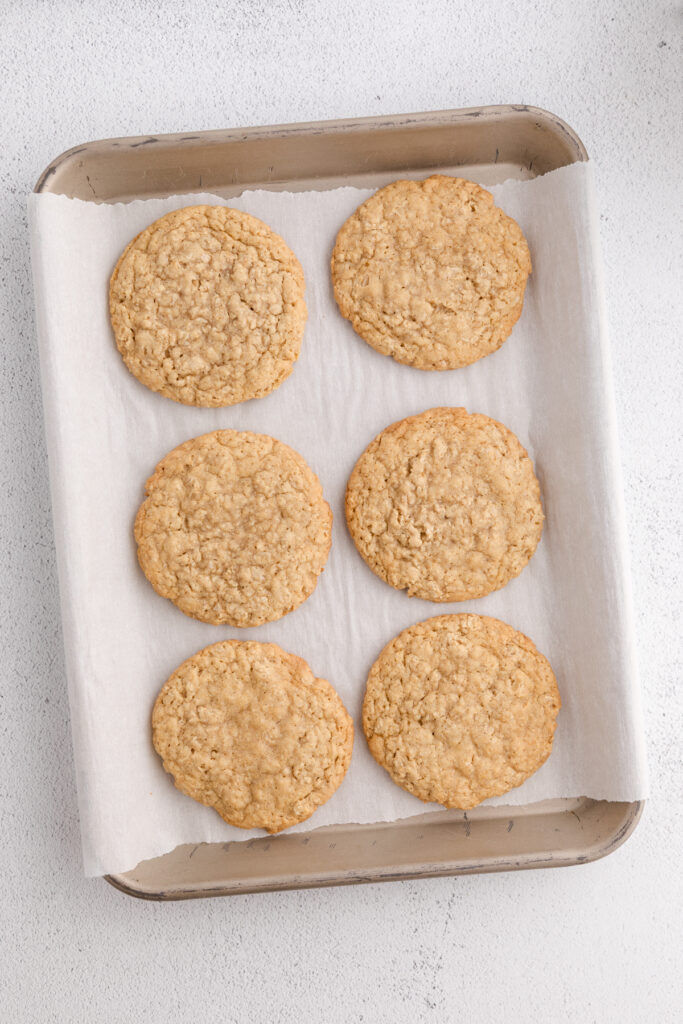 top down image showing a parchment lined tray with baked cookies