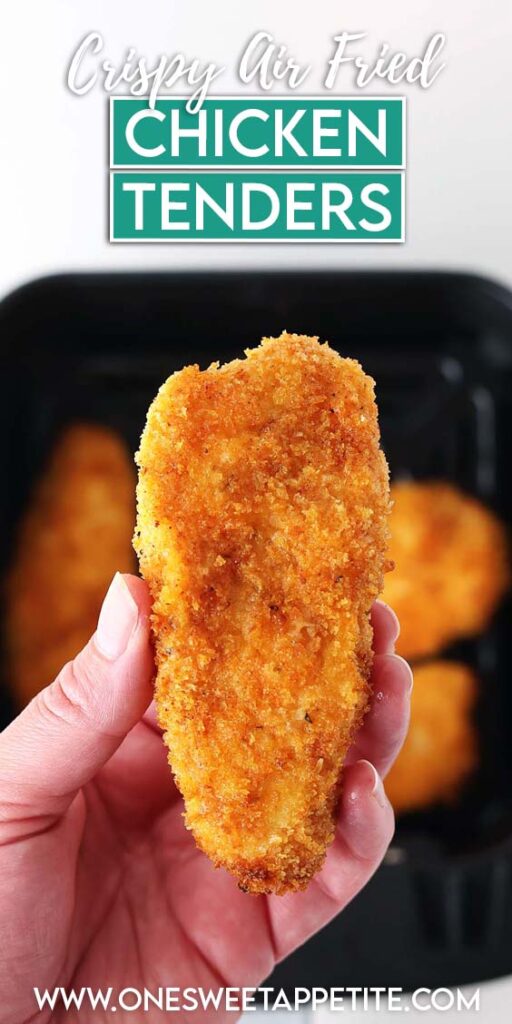 hand holding a golden crispy tender over more tenders sitting in the air fryer