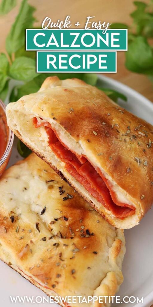 Close up image showing a calzone that has been cut in half and stacked on a white plate with a side of pizza sauce and basil. Text overlay reads Quick + Easy Calzone Recipe"