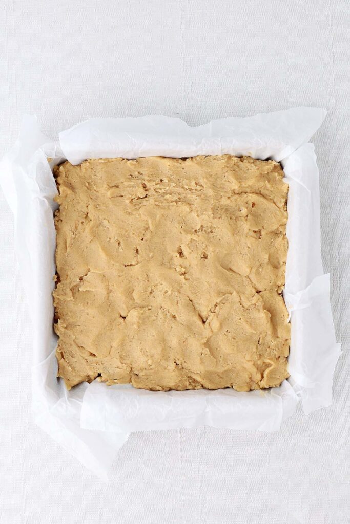 Top down image showing a parchment lined pam with blondies inside