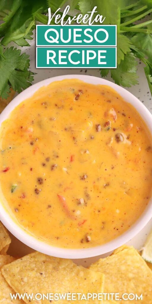 Creamy Velveeta queso dip in a white bowl, topped with sausage crumbles and diced peppers, served with tortilla chips and fresh cilantro in the background.