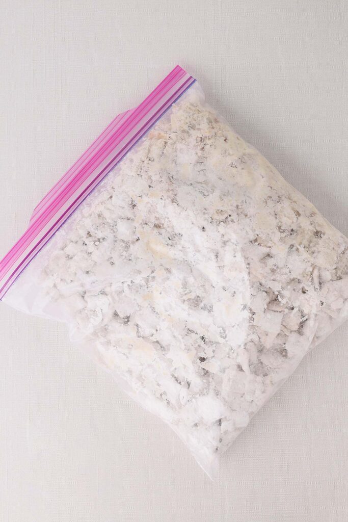 Top down image showing a gallon zip top bag filled with cereal and powdered sugar