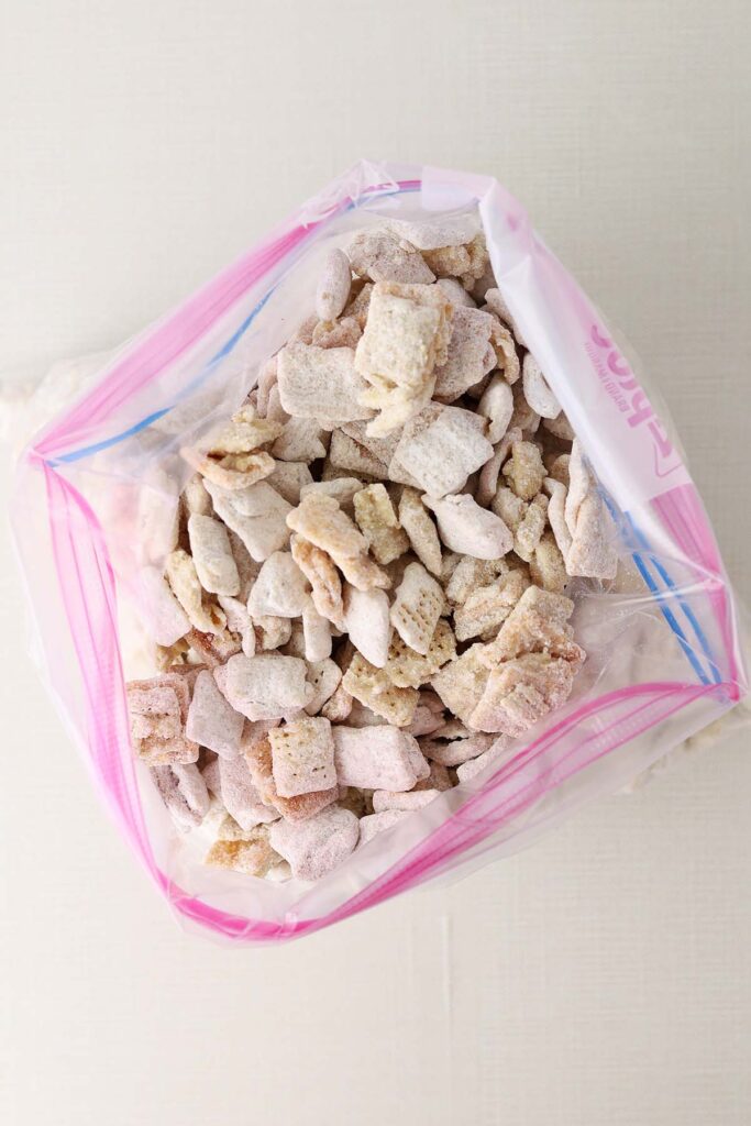 Top down image showing a zip top bag filled with powdered sugar and cereal