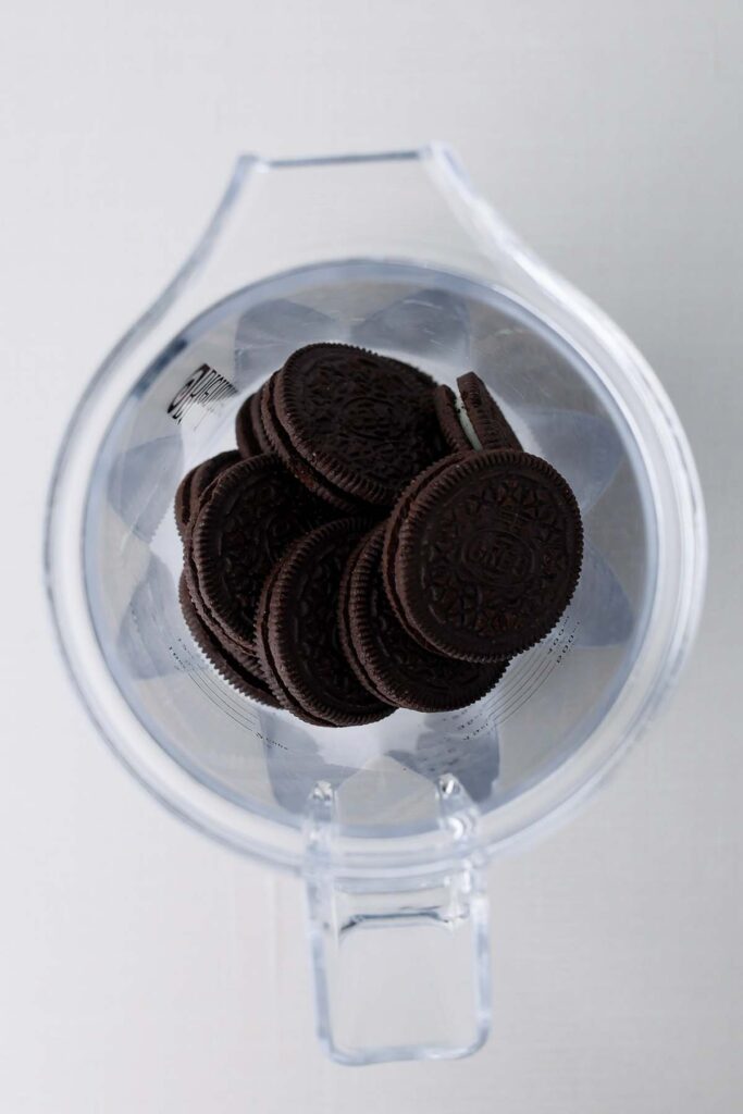 Top down image showing a blender top down filled with oreo cookies