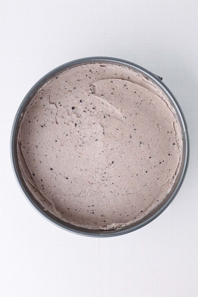 top down image showing an 8 inch pan filled with a cookies and cream filling