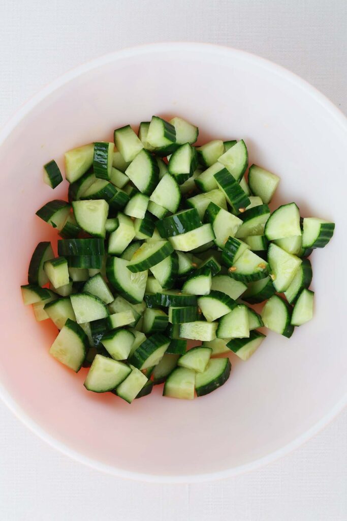 close up top down image showing chopped cucumbers in a bowl