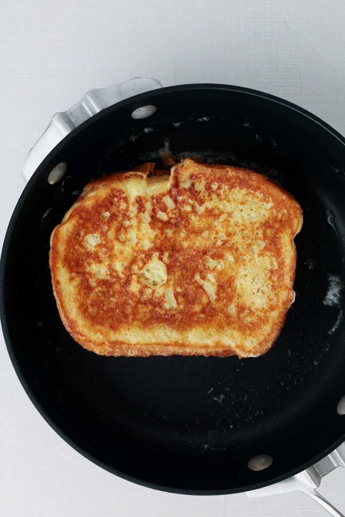 top down image showing a small black skillet with french toast browned inside.